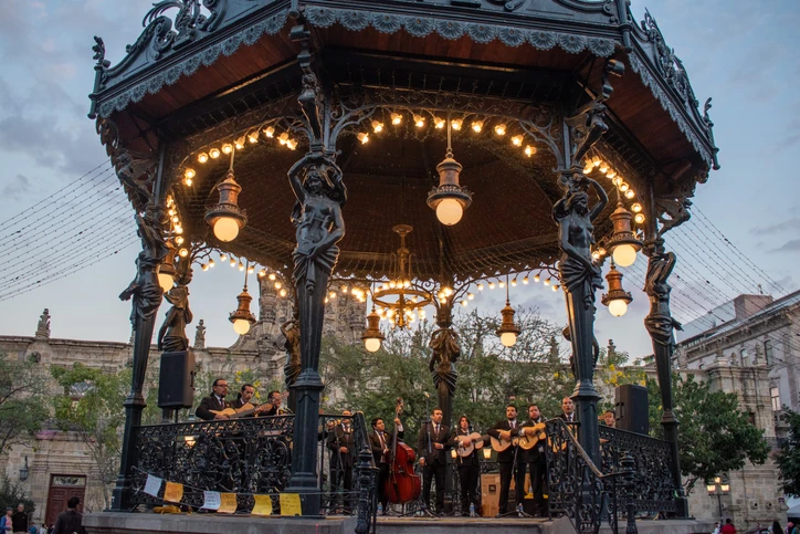 Grupo de músicos mariachis tocando dentro del Kiosco de Plaza de Armas.