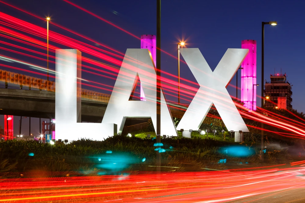 Big LAX sign outside the airport at night.