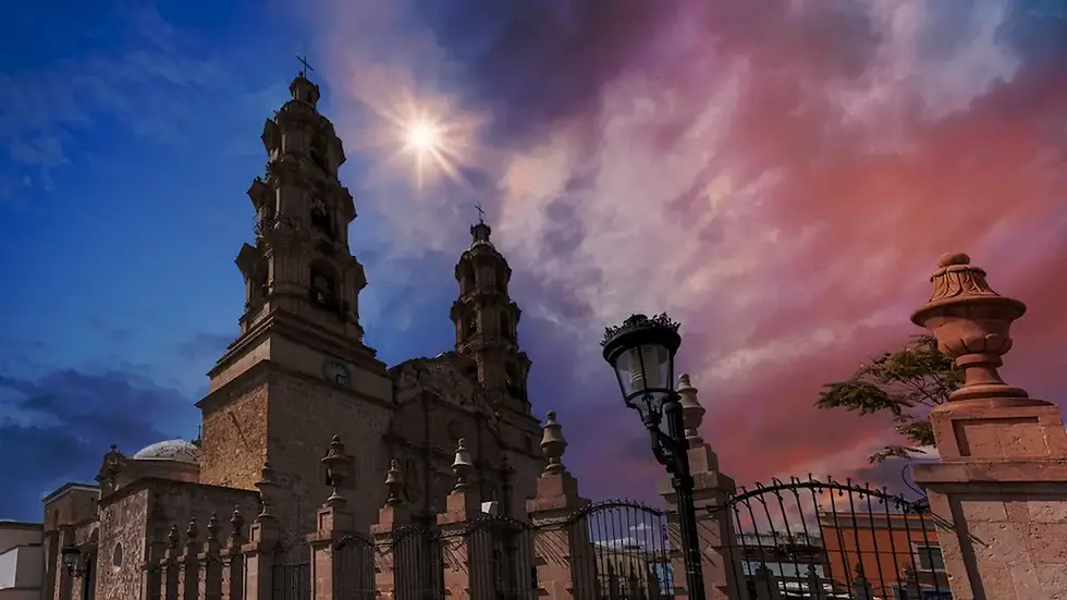 Historic cathedral under a dramatic sunset sky showing Aguascalientes weather conditions at dusk