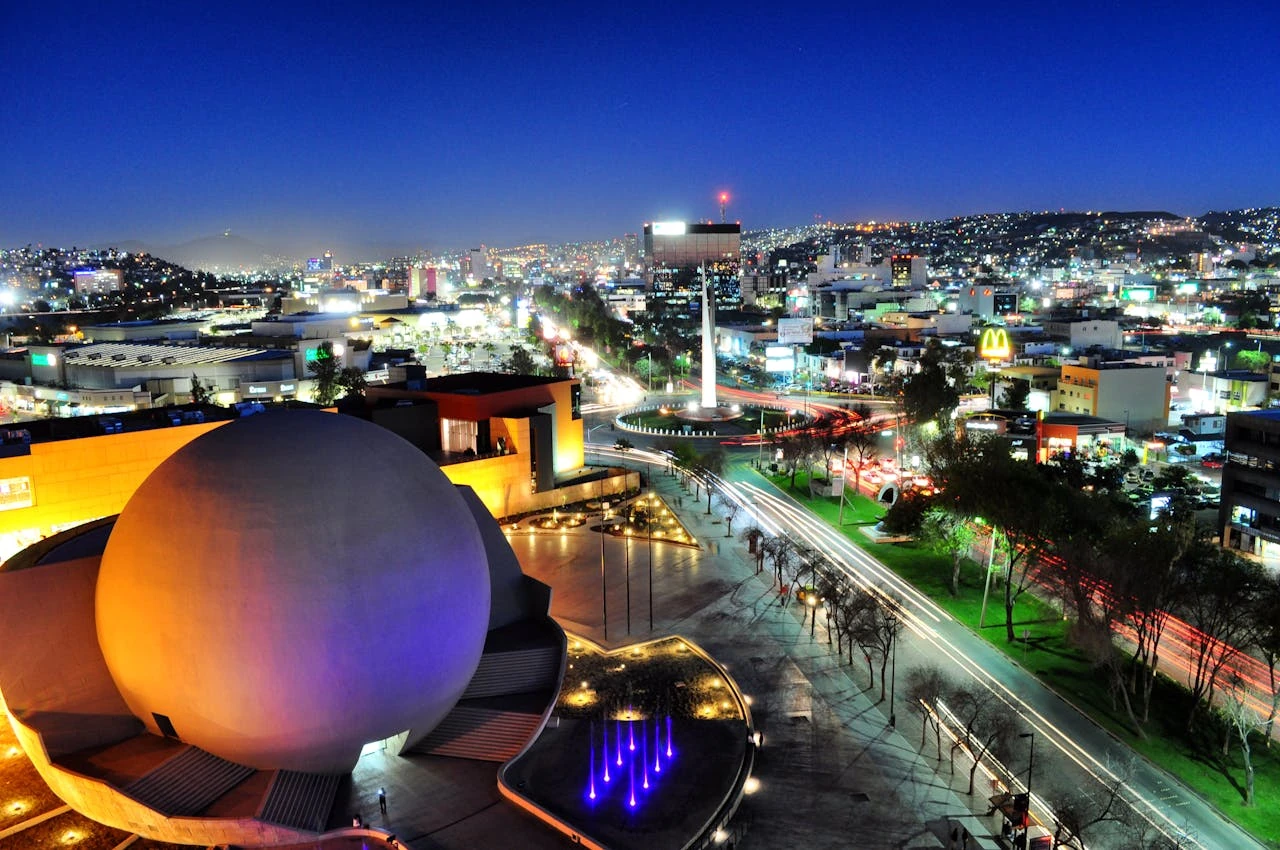 Aerial view of CECUT and surrounding blocks at night.