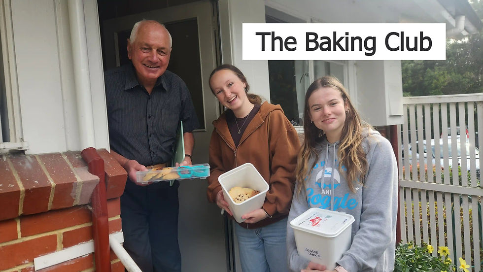 Salmond College Dunedin residents, Eva and Caitlin, deliver baking to Clive, one of the college’s neighbours.