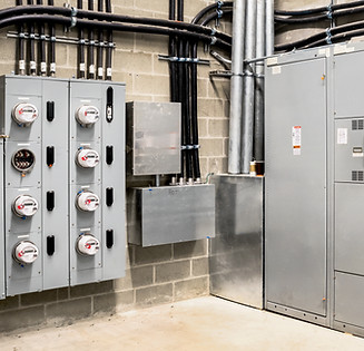 Electrical room of residential or commercial building. Multiple smart meters, main power b
