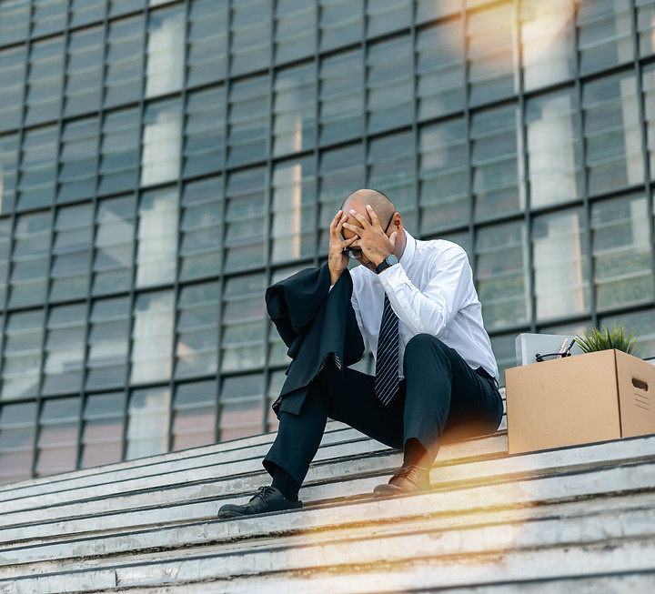 Sadness depressed Businessman with box cardboard packing personal items after losing jobs.