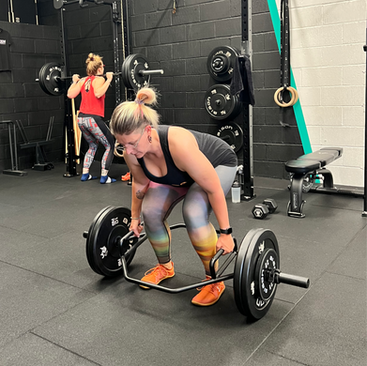 Woman doing a deadlift in a gym