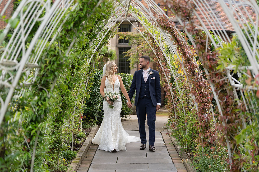 Videographer films couple at garden wedding