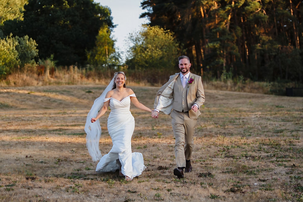 Eye-level view of a videographer filming a bride laughing naturally