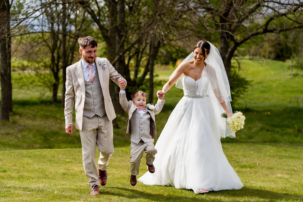 Eye-level view of a bride walking through a sunlit garden path