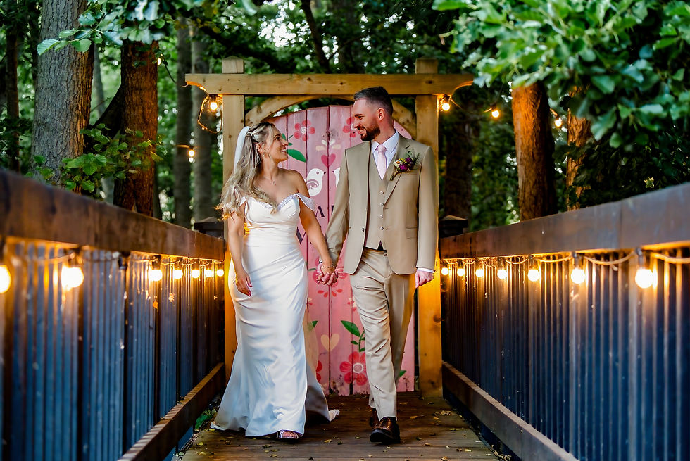 Wide angle view of a rustic wedding venue decorated with fairy lights at dusk