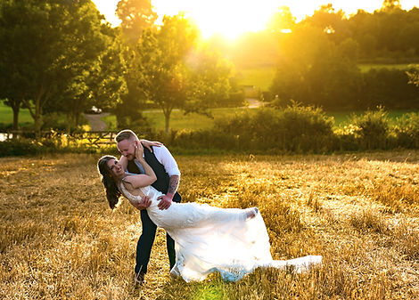 Couple embracing in a field at sunset, Ever Thine Film & Photography, Wedding Photographer.