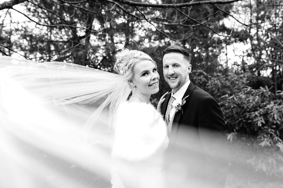 Bride and groom laughing after rainy ceremony