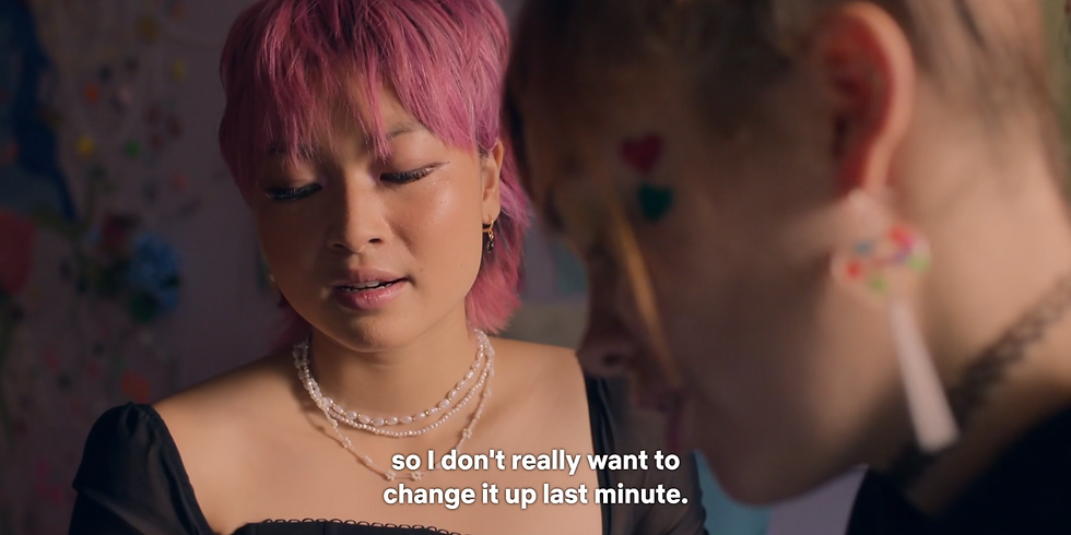 Sasha looks down at her phone, disappointed. Quinni is still explaining. Subtitle reads, "so I don't really want to change it up last minute."