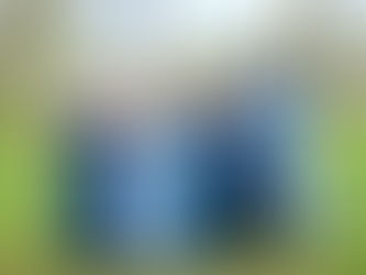 Bridesmaids wearing blue dresses linking arms andwalking