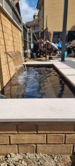 Modern pond with acrylic water blade