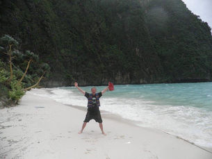 A man celebrates on a beach in Thailand