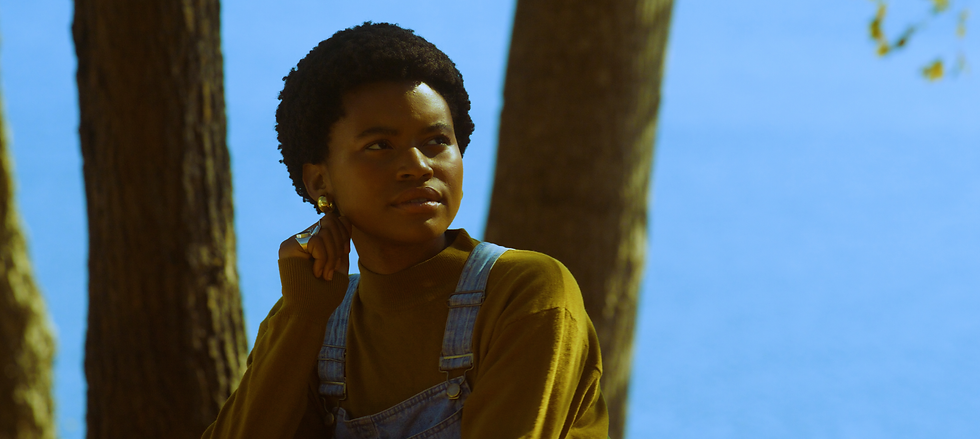 The love interest sitting by a lake