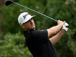 Canadian golfer swinging a driver during a professional tournament.