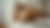 A Golden Retriever puppy sleeps on a sofa with a pair of eye glasses sitting next to it.