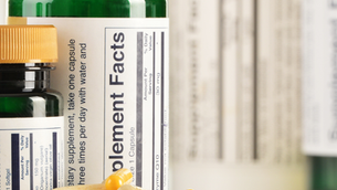 Decorative photo of supplement bottles and supplement capsules. 