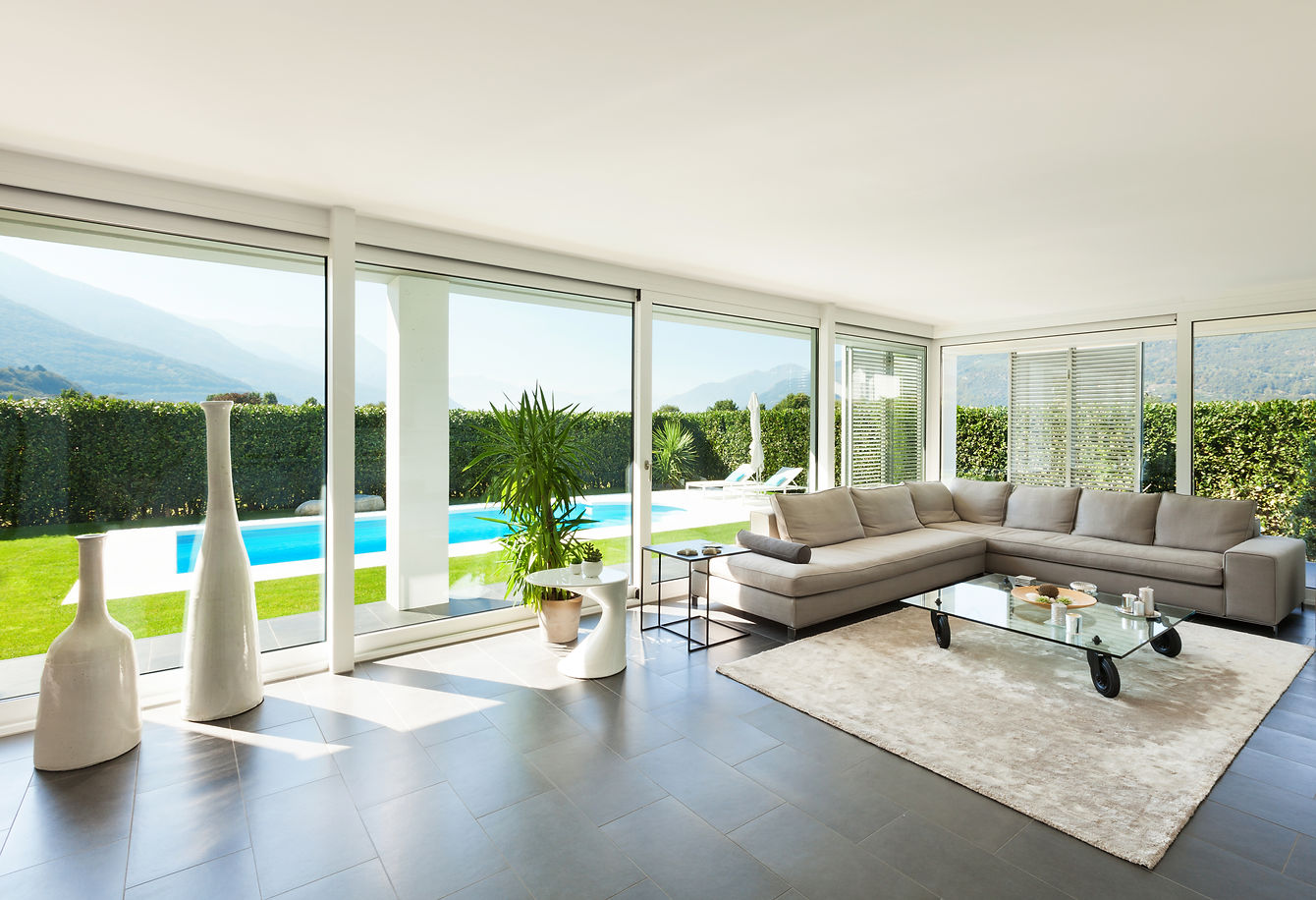 Photo of a living room with pool in background