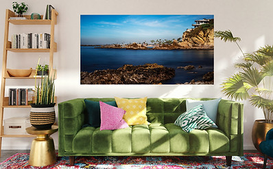Coastal wall art above a vibrant green sofa in a modern living room — showcasing framed ocean photography as bold home décor