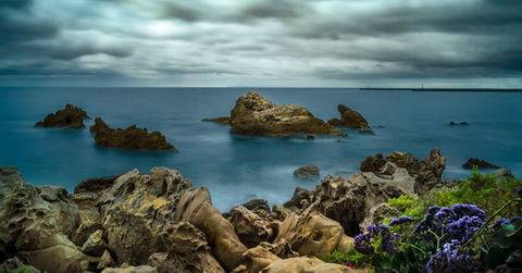 Slow shutter image of ocean tide and rocks at Little Corona Beach
