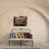 Thumbnail: Desert landscape print hung above a vibrant accent sofa in a southwestern-style room with arched architecture.