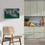 Thumbnail: Vibrant surf artwork hanging on a pale green kitchen wall above a natural wood chair and tiled backsplash.