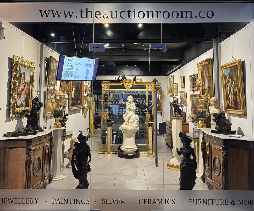 Auction room with sculptures, paintings, and antiques. Central white statue, gold-framed mirror. Screen displays "Sold for £800". Elegant ambiance.