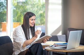 young-woman-sits-front-laptop-studies-remotely.jpg
