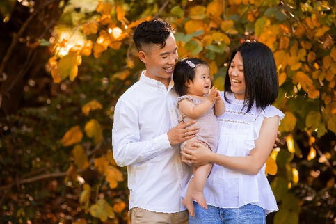Asian family, dad holding baby, autumn leaves