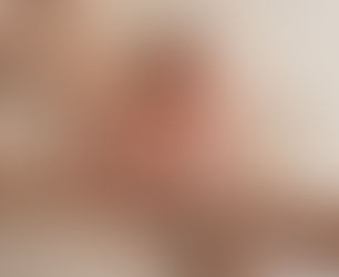 Newborn baby sleeping wrapped in parent's arms during newborn photography Brisbane session