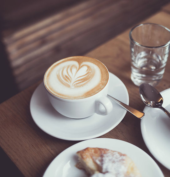 Table with coffee and pastry.