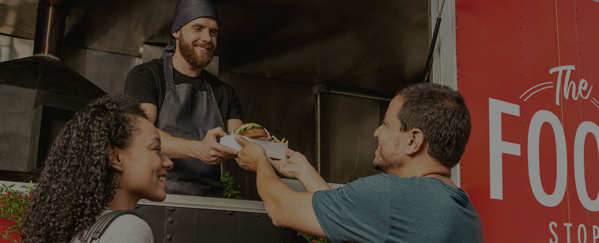 People buying food from a red food truck