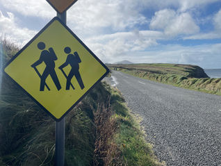 A road sign containing two hikers