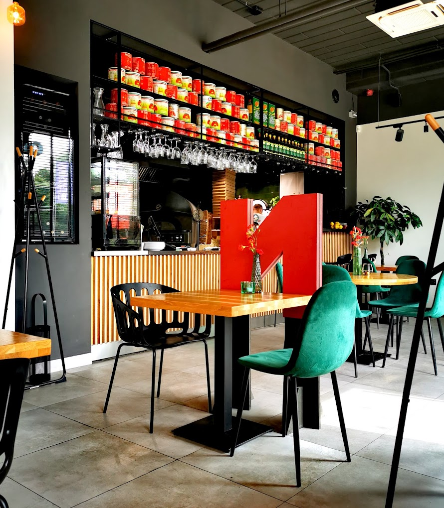 table and chairs in a pizzeria red and green