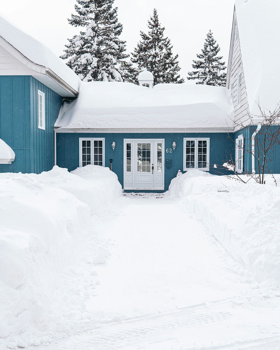 A blue house in Montreal, Canada, covered with a thick layer of snow.