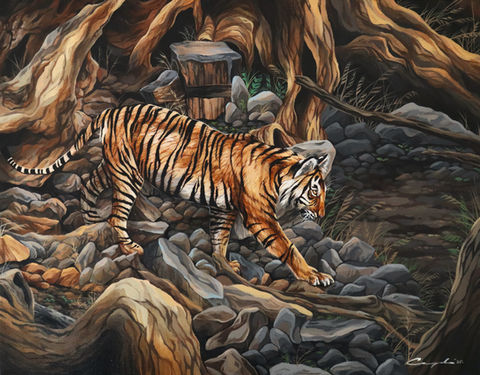 Tiger walking through a forest with a golden glow.