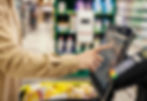 Person using self-checkout kiosk