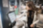 Woman using self-checkout kiosk.