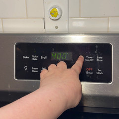 hand changing oven temperature