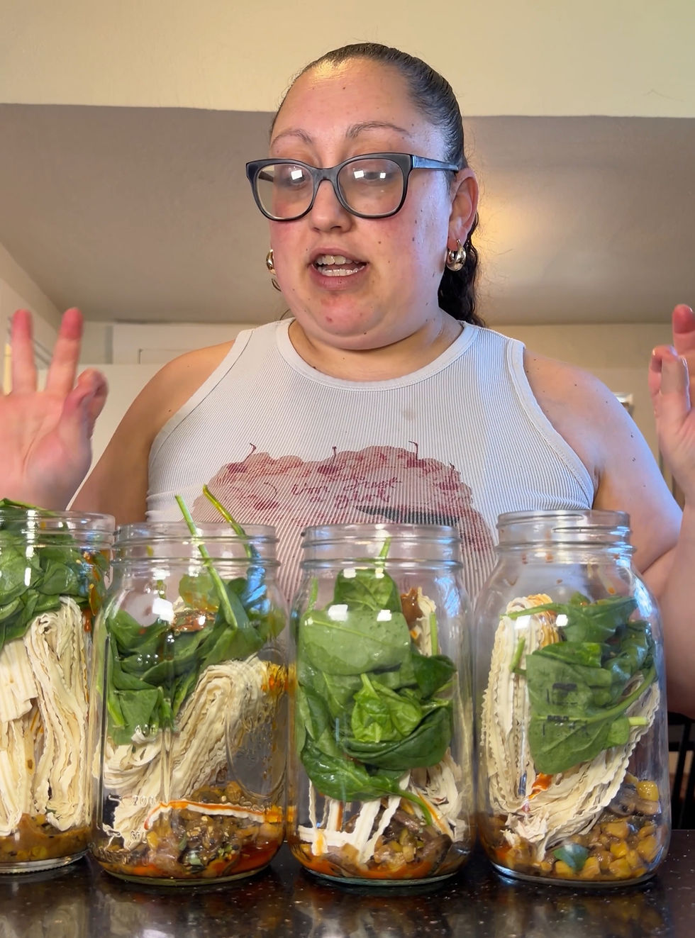 4 glass jars filled with ramen ingredients
