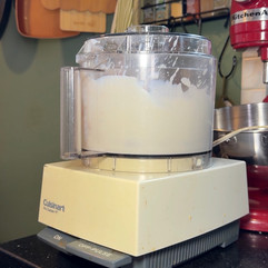 food processor blending milk and cake