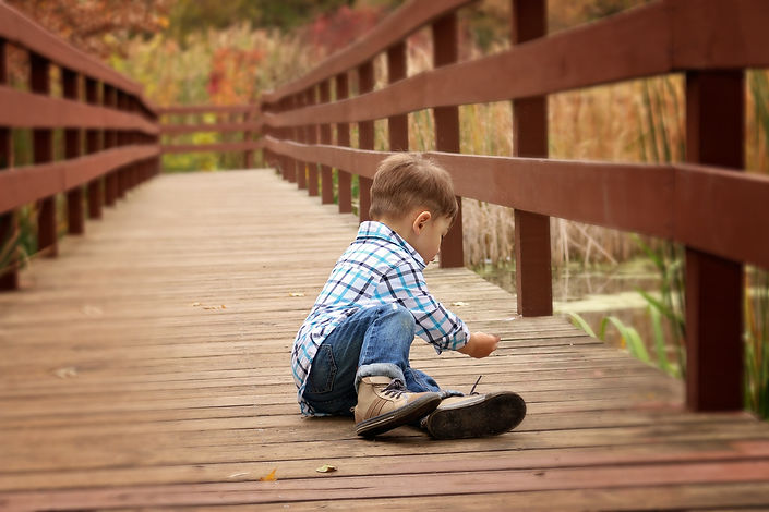 boy by self on bridge.jpeg