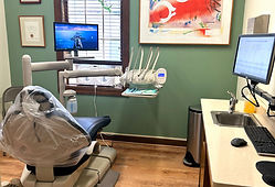 Modern dental exam room with patient chair and equipment