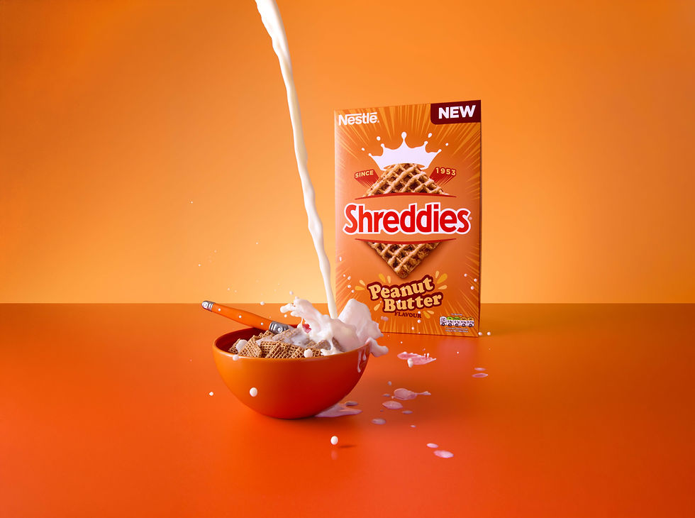 Nestlé Shreddies Peanut Butter cereal with dynamic milk splash, commercial food photography by Richard Jarrett, London.