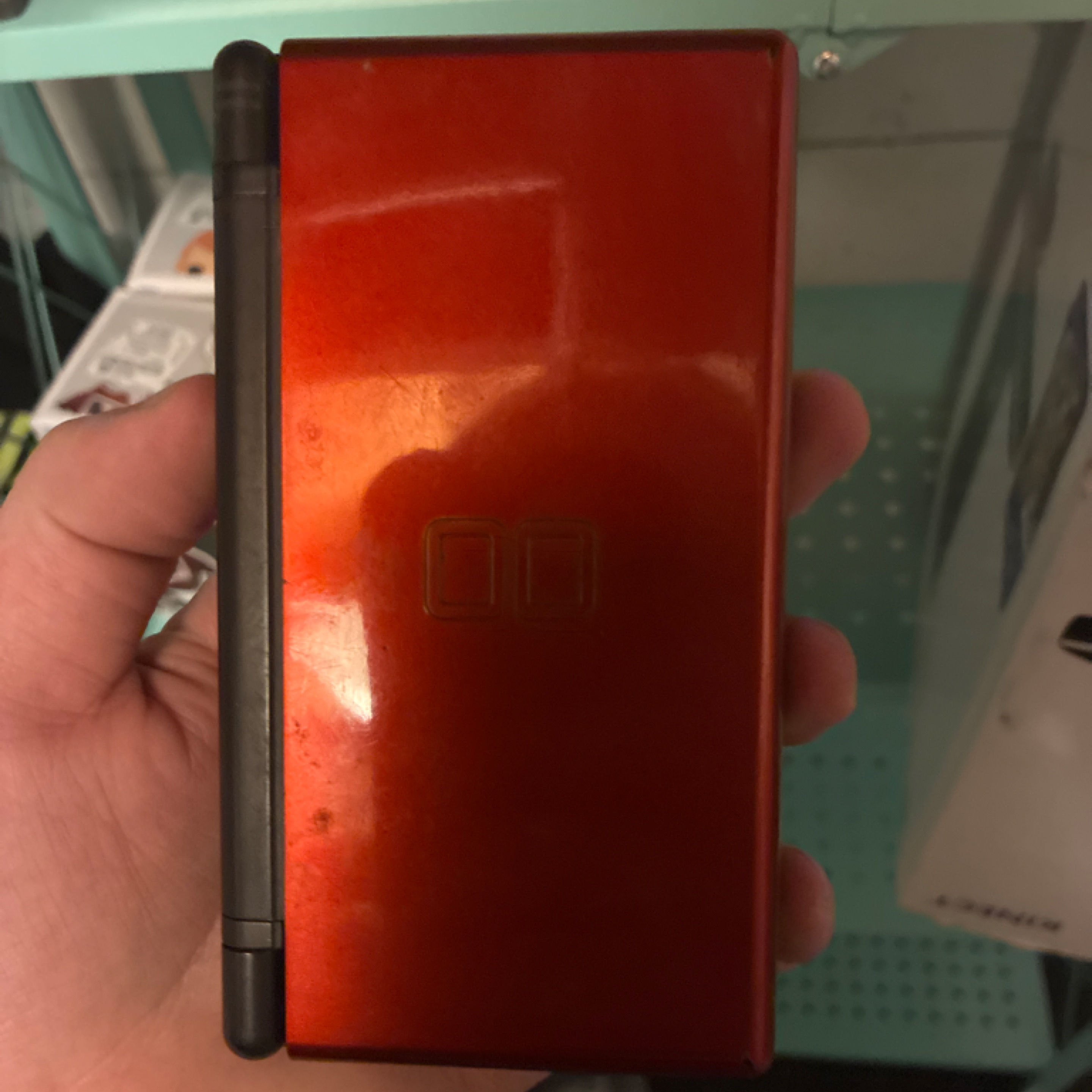 Red and Black Nintendo DS Lite with charger