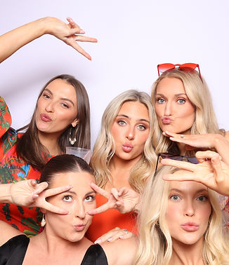 Guests laughing and posing in photo booth at Little Rock wedding