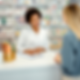 Pharmacist assisting a patient at the counter during a pharmacy consultation