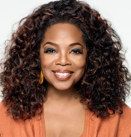Oprah Winfrey with radiant, smooth skin and a warm smile, reflecting her timeless beauty and commitment to wellness.