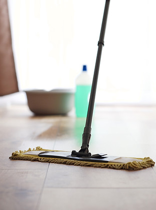 vecteezy_man-washing-floor-with-cleaning-agent-cleaning-agent-bottle_49588065.jpg
